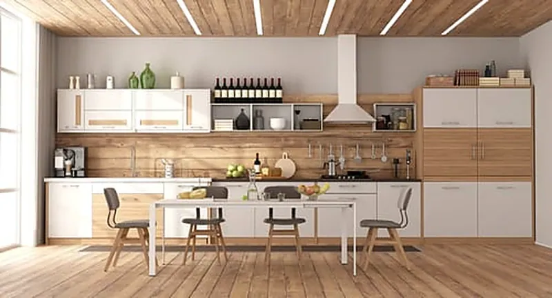 Modern kitchen with light wood cabinetry and new flooring after a remodel