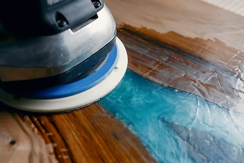 Floor sander refinishing a hardwood floor during a MB Flooring & Home Services project in Washington