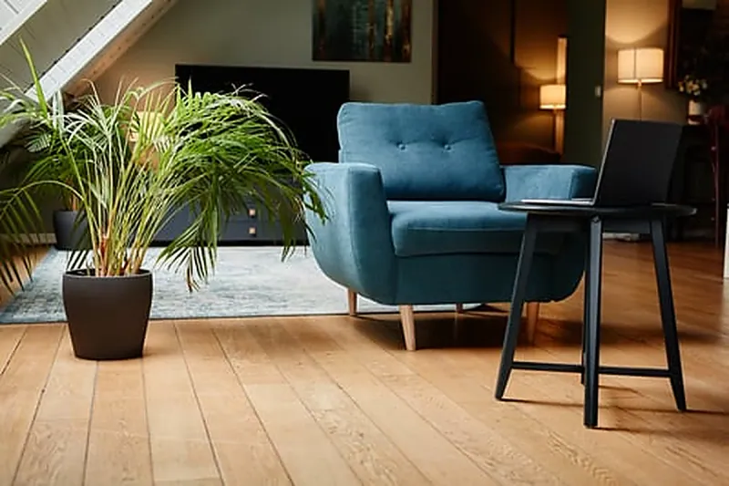 Bright living room with light oak laminate flooring installed by MB Flooring & Home Services